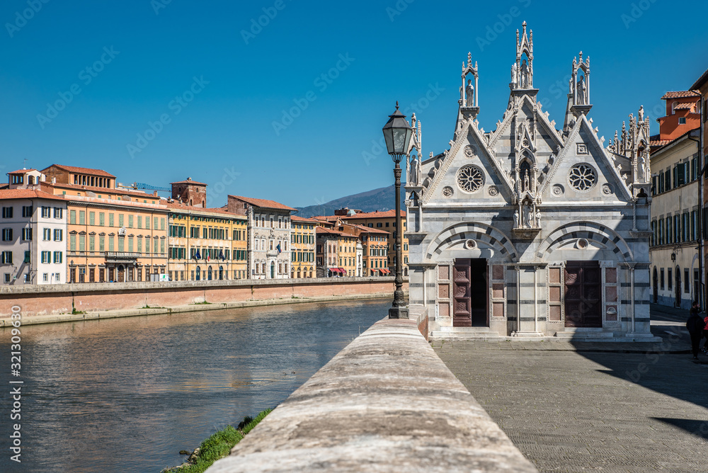 Little gothic Santa Maria della Spina church in Pisa on the bank of Arno river in sunny spring day