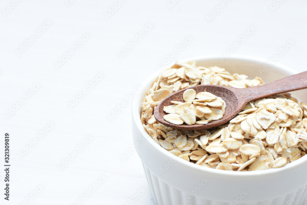 Natural oatmeal on light wooden background Natural oatmeal on light wooden background