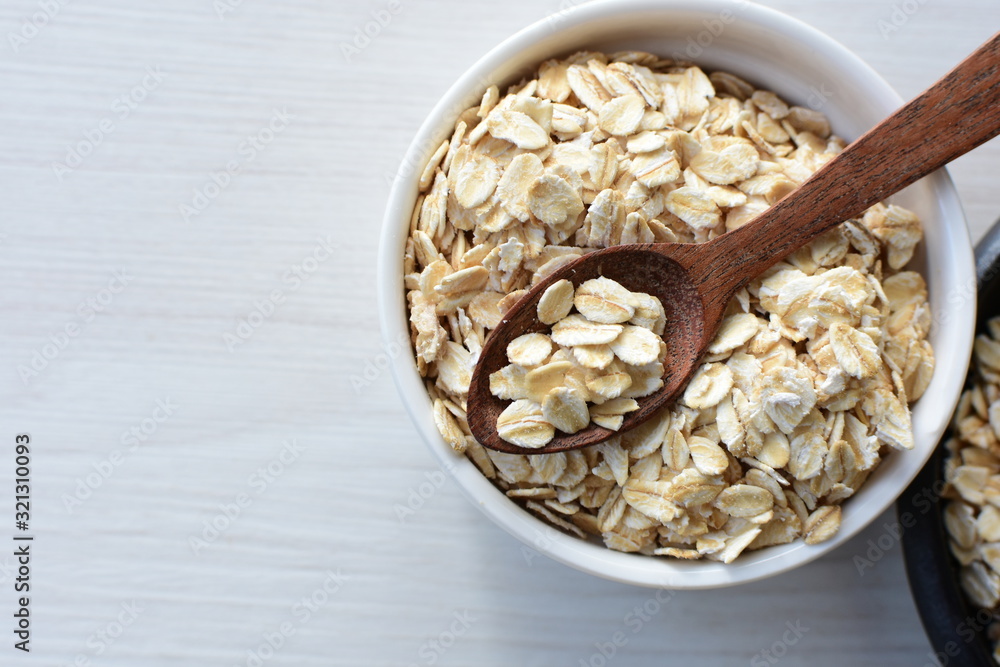 Natural oatmeal on light wooden background Natural oatmeal on light wooden background