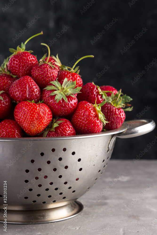 Fresh juicy strawberries from the garden in an iron bowl on the table. Heap of fresh strawberries in an iron bowl on rustic white wooden background. Fresh organic berries macro. Free space for text. Fresh juicy strawberries from the garden in an iron bowl on the table. Heap of fresh strawberries in an iron bowl on rustic white wooden background. Fresh organic berries macro. Free space for text.