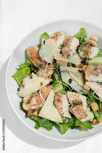 organic chicken caesar salad with parmesan cheese and croutons