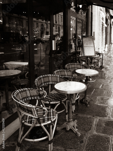 Wallpaper Mural Paris, France, Parisian cafe, tables and chairs on paved sidewalk, black and white photo. Torontodigital.ca