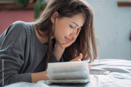 Beautiful exhausted female student preparing for upcoming examination.