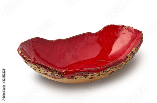Red handmade glazed ceramic plate isolated on white background
