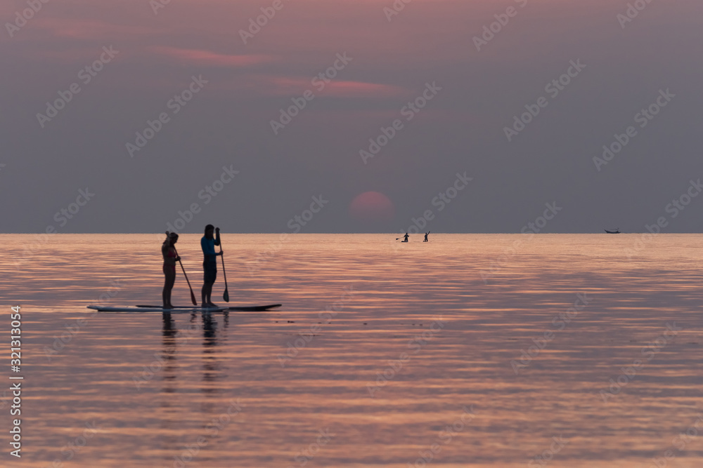 Stand up paddle boarding on quiet sea