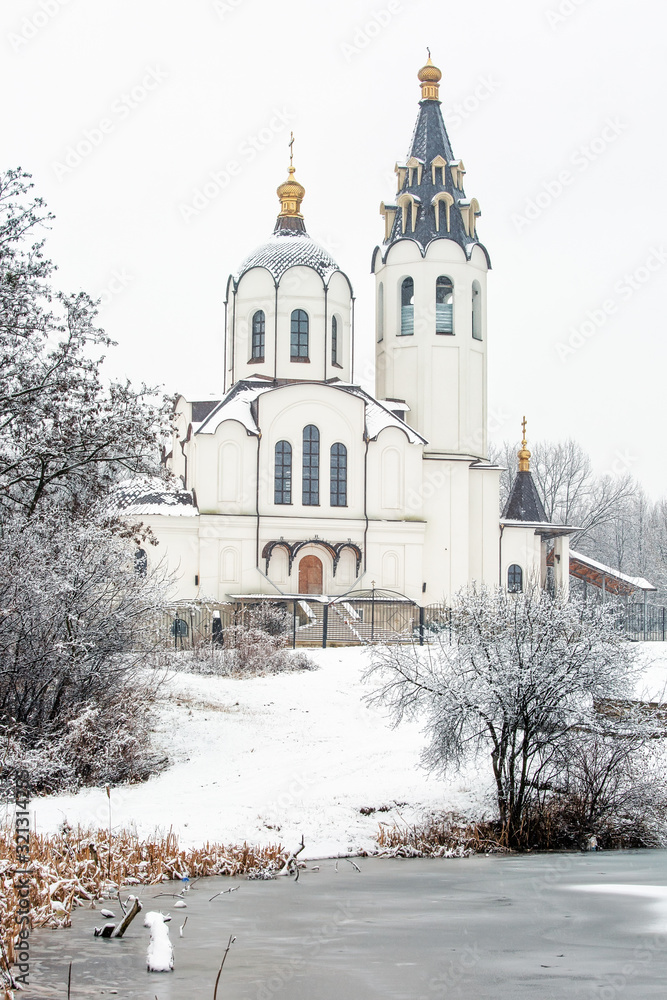 Beautiful white church near the lake in winter Beautiful white church near the lake in winter