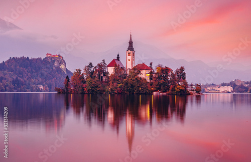 Scenic image of Fairytale lake Bled during sunset. Natural summer scenery with colorful sky. Fantastic Picturesque Scene over famouse lake. Julian Alps. Slovenia. Wonderful Autumn landscape.