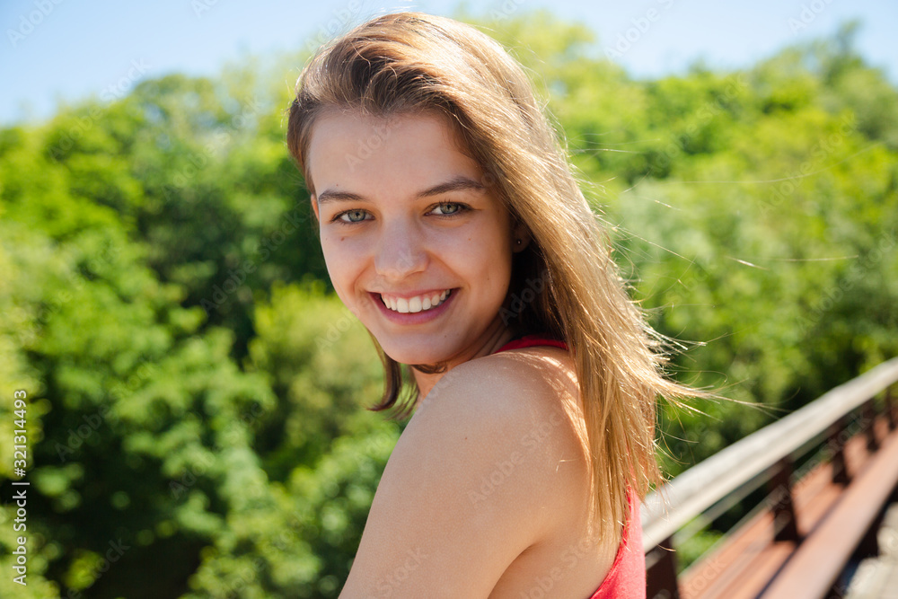 Portrait of a happy beautiful teen girl smiling in a sunny day Portrait of a happy beautiful teen girl smiling in a sunny day