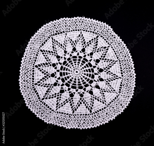 Vászonkép White hand made crocheted coaster lace doily on black background