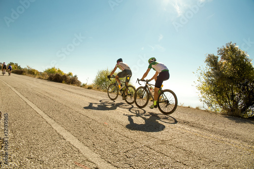 Fototapeta bike race in the morning on  uphill road
