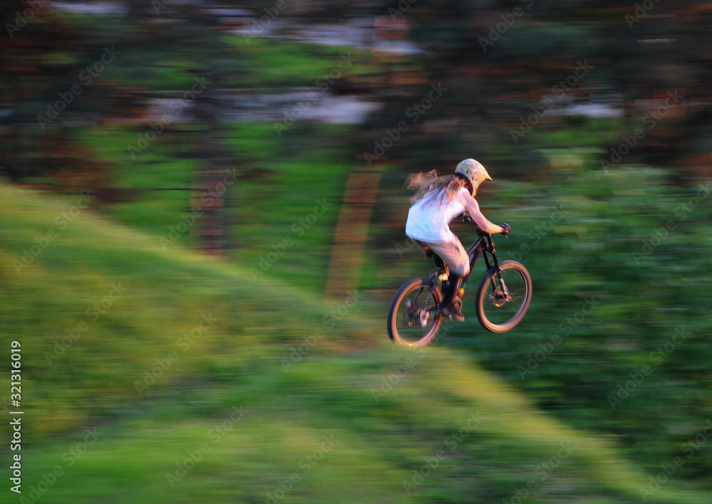 Young man jump with mountain bike across the edge Young man jump with mountain bike across the edge