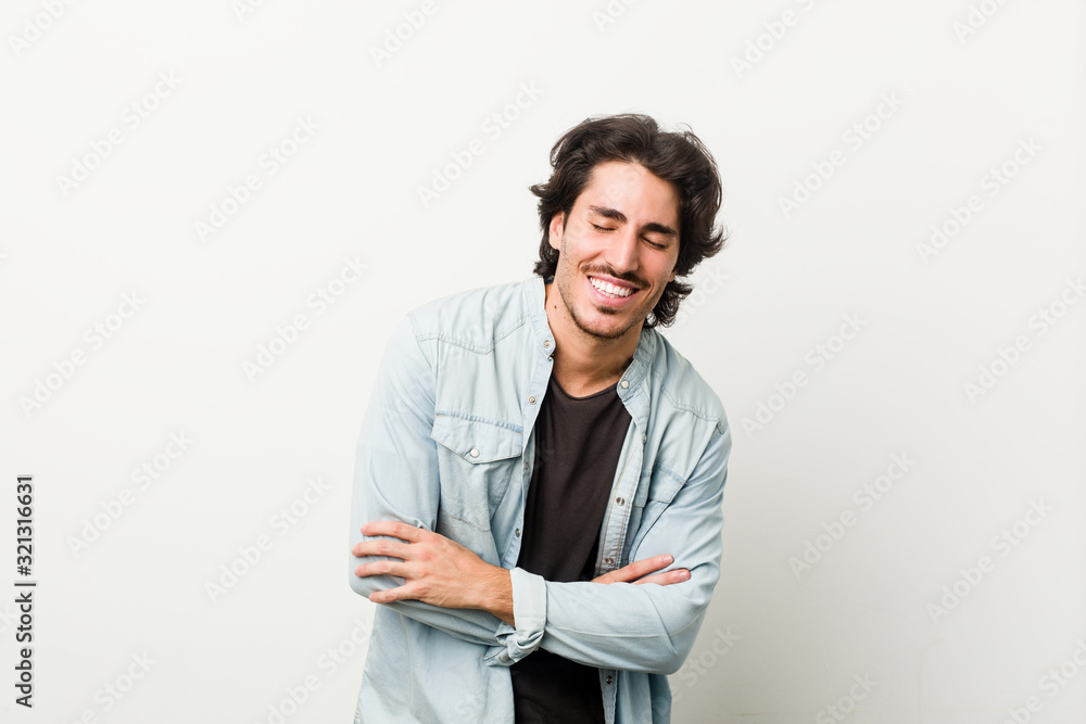 Young handsome man against a white background laughing and having fun. Young handsome man against a white background laughing and having fun.