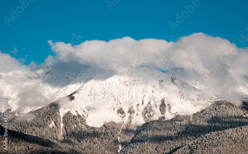 mountain ski resort Rosa Khutor in Sochi. Winter sunny day with cloudy .