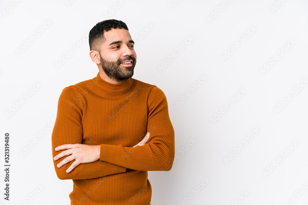 Young latin man against a white background isolated smiling confident with crossed arms. Young latin man against a white background isolated smiling confident with crossed arms.