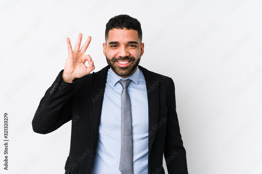 Young latin business woman against a white background isolated cheerful and confident showing ok gesture. Young latin business woman against a white background isolated cheerful and confident showing ok gesture.