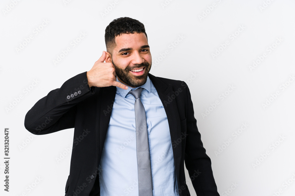 Young latin business woman against a white background isolated showing a mobile phone call gesture with fingers. Young latin business woman against a white background isolated showing a mobile phone call gesture with fingers.