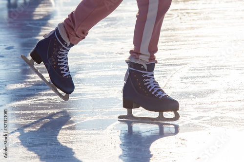 girl ice skating on an ice rink. hobbies and leisure. winter sports