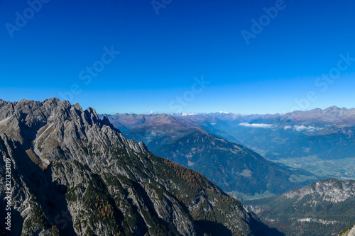 A panoramic view on Lienz Dolomites, Austria from the top of Grosse Gamswiesenspitze. Endless mountain chains and green valleys. High mountain climbing. Freedom and solitude