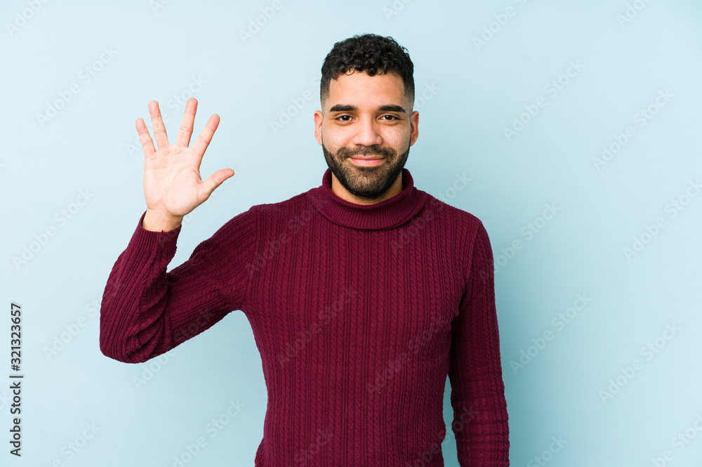 Young mixed race arabic man isolated smiling cheerful showing number five with fingers. Young mixed race arabic man isolated smiling cheerful showing number five with fingers.