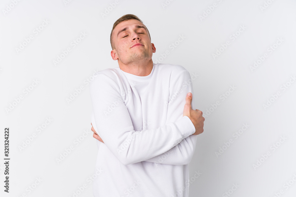 Young caucasian man on white background hugs, smiling carefree and happy. Young caucasian man on white background hugs, smiling carefree and happy.