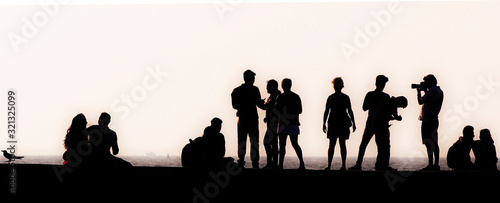 a group of people in a black and white frame near the sea with diffrent activites