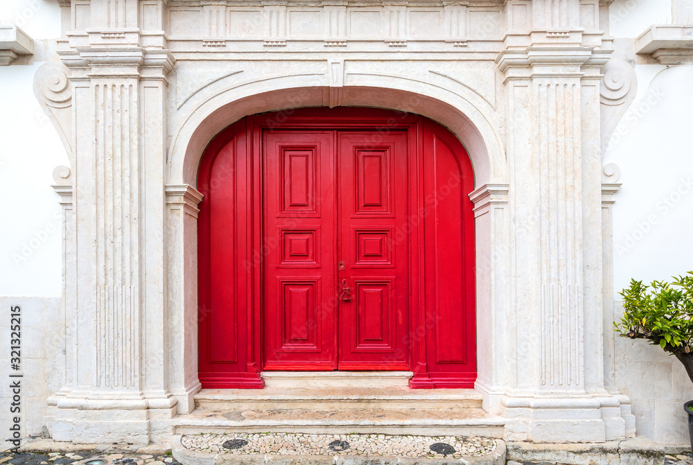 red door on white facade