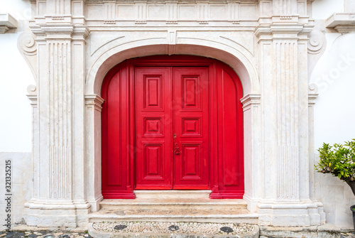 red door on white facade © AlenKadr