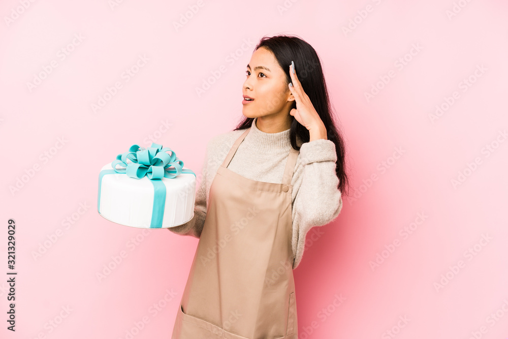 Young chinese woman holding a cake isolated being shocked, she has remembered important meeting. Young chinese woman holding a cake isolated being shocked, she has remembered important meeting.