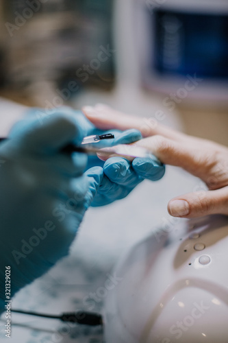 woman applying nail polish on her fingers