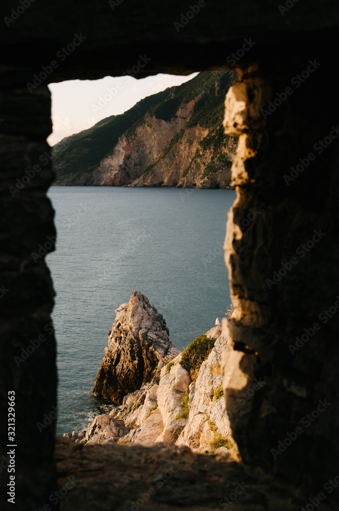Liguria's Coastline view through a stone wall, Portovenere, Italy