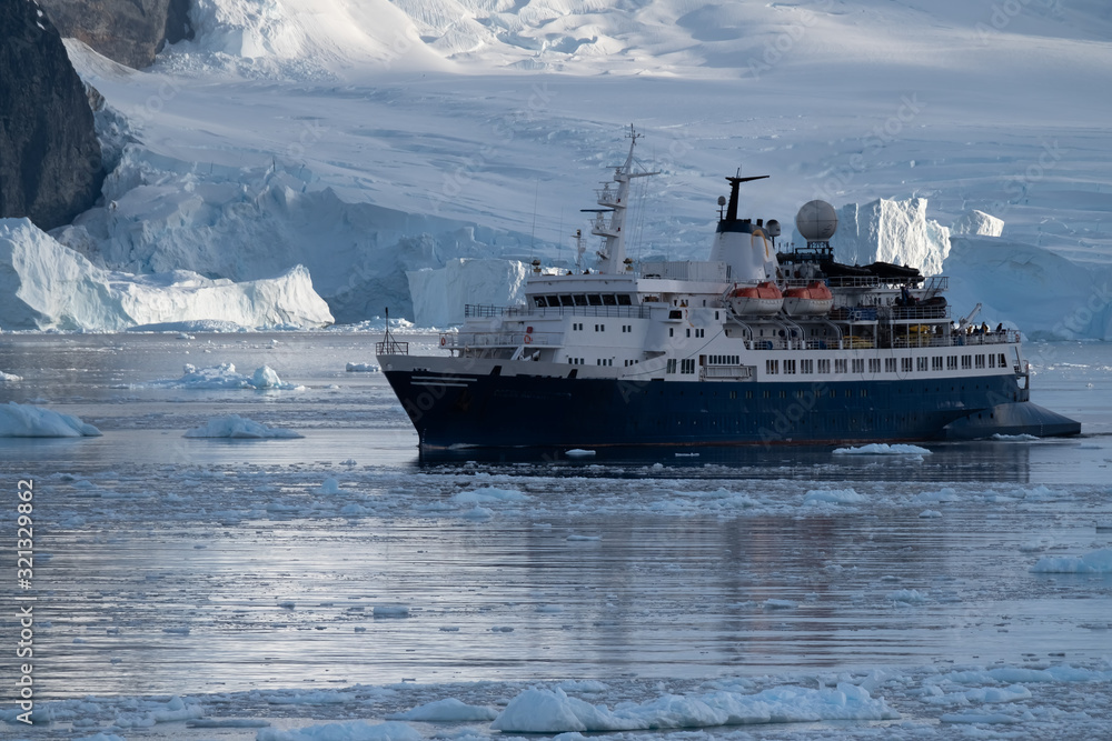 Cruise ship navigating through the stunning icy landscapes, Cuverville Island, Antarctic Peninsula, Antarctica Cruise ship navigating through the stunning icy landscapes, Cuverville Island, Antarctic Peninsula, Antarctica