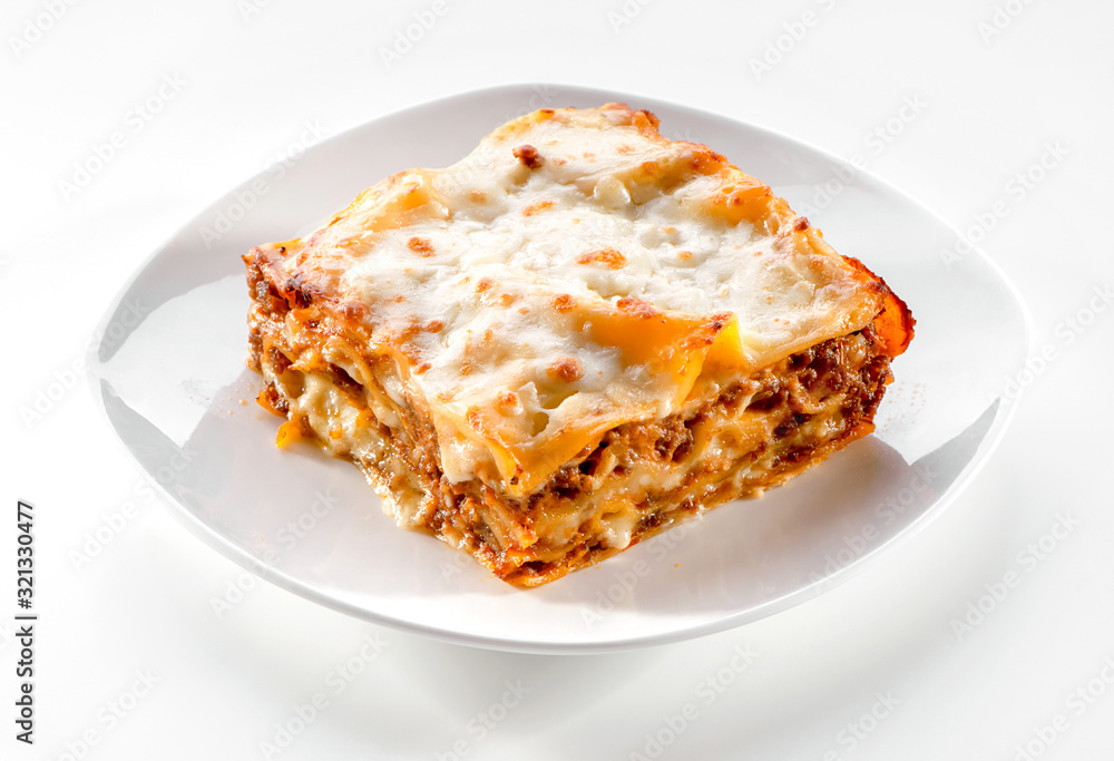 lasagna piece plate with minced meat and melted cheese close-up on white background - obrazy, fototapety, plakaty 