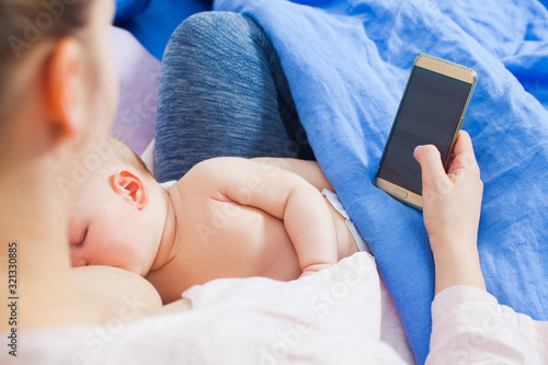 Close view of newborn baby breastfeeeding and sleeping photo