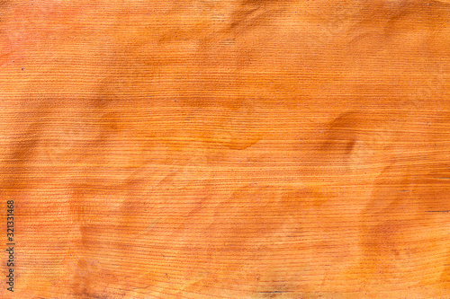 Avola Pine Orange wooden texture. Linear wooden surface texture. Bitmap image. Photography. Nut-pine pattern. Veneer linear pattern on orange wooden wall background. Structure of wooden panel.
