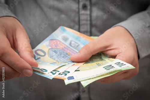 Man counts Euro banknotes.