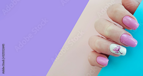 female hand nail beautiful manicure on a colored background, banner