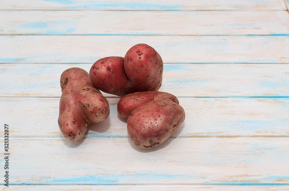 Two ugly potatos on the white wooden background. Food waste concept. Copy space. Two ugly potatos on the white wooden background. Food waste concept. Copy space.
