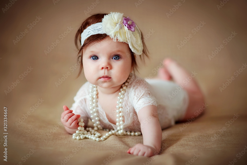 little girl baby in beads and jewelry