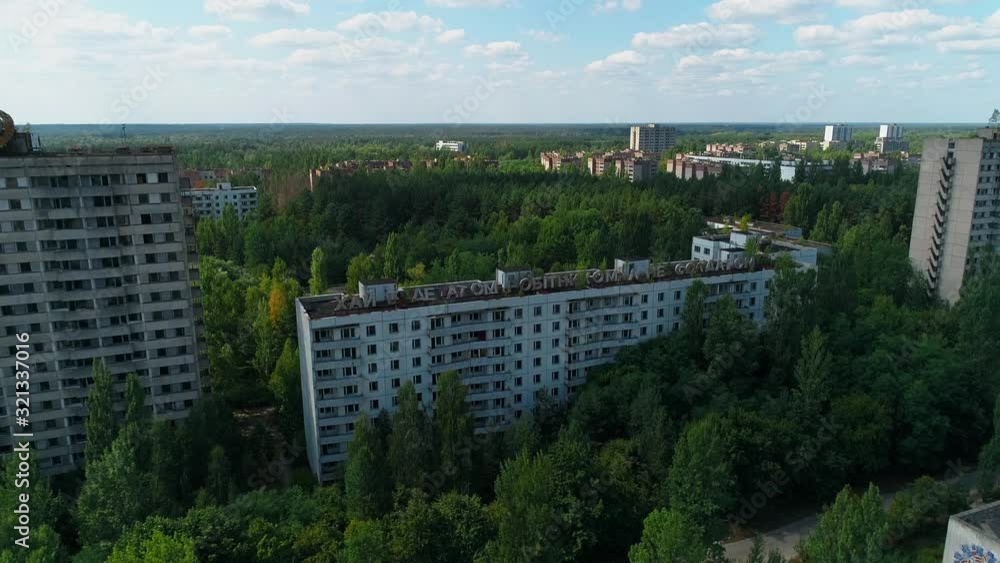 Aerial view of abandoned buildings and streets in city Pripyat near Chernobyl nuclear power plant. Cyrillic inscription Aerial view of abandoned buildings and streets in city Pripyat near Chernobyl nuclear power plant. Cyrillic inscription