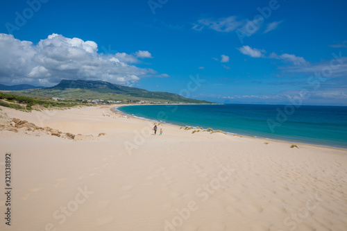 beautiful landscape of wild natural Beach Bolonia in Tarifa  Cadiz  Andalusia  Spain  with woman and little girl walking. Copy or text space