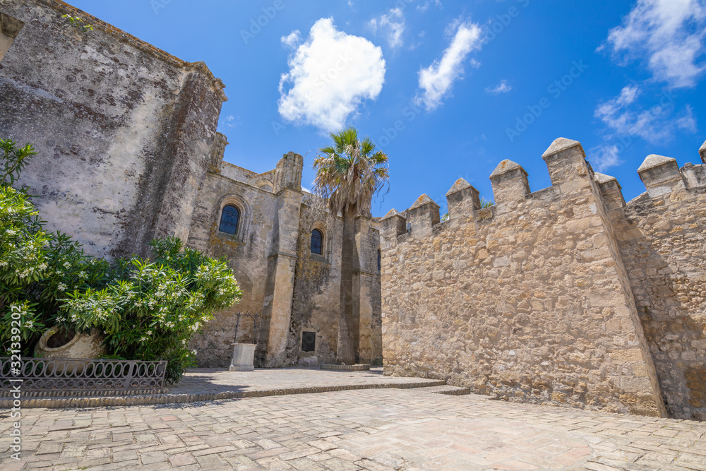 public square with Segur Gate wall, from XV century, and side of Church the Divine Savior, in Vejer de la Frontera (Cadiz, Andalusia, Spain, Europe)