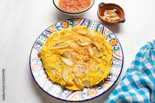 Spanish scrambled eggs with potatoes called tortilla or tapa on white background