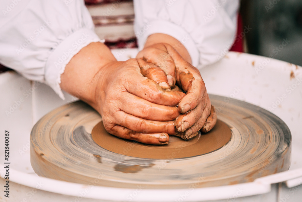 Process Of Creating A Clay Pot. Using Hands. Pottery Craft Wheel And Ceramic Clay Pot. Close Up