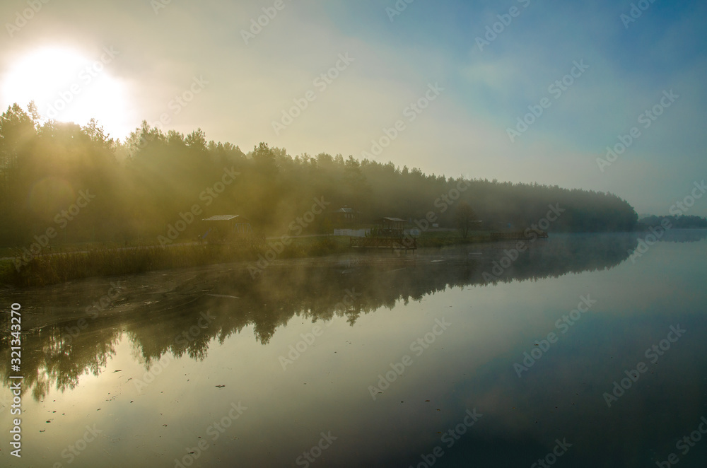 autumn landscape. Mist over the river and trees. Forest in the fog. Backlight sunlight. Beautiful sunrise in the clear sky. autumn landscape. Mist over the river and trees. Forest in the fog. Backlight sunlight. Beautiful sunrise in the clear sky.