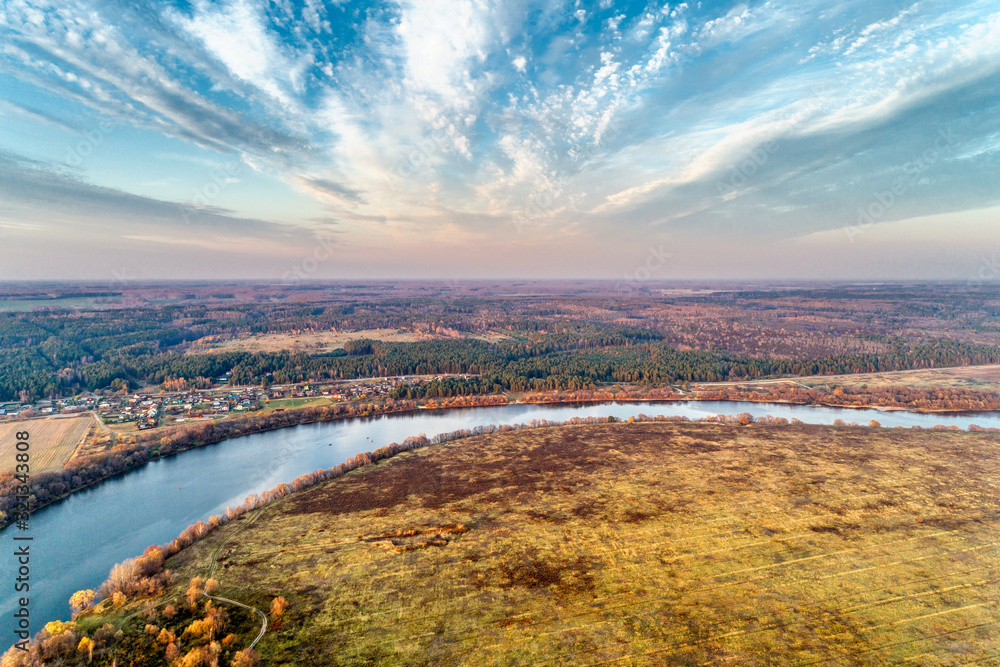Bend of a wide river. Autumn landscape aerial view