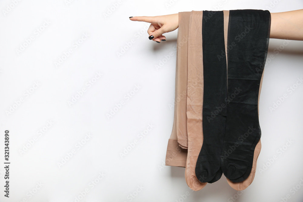 custom made wallpaper toronto digitalwoman's hand holding new pantyhose and stockings and pointing direction with her finger