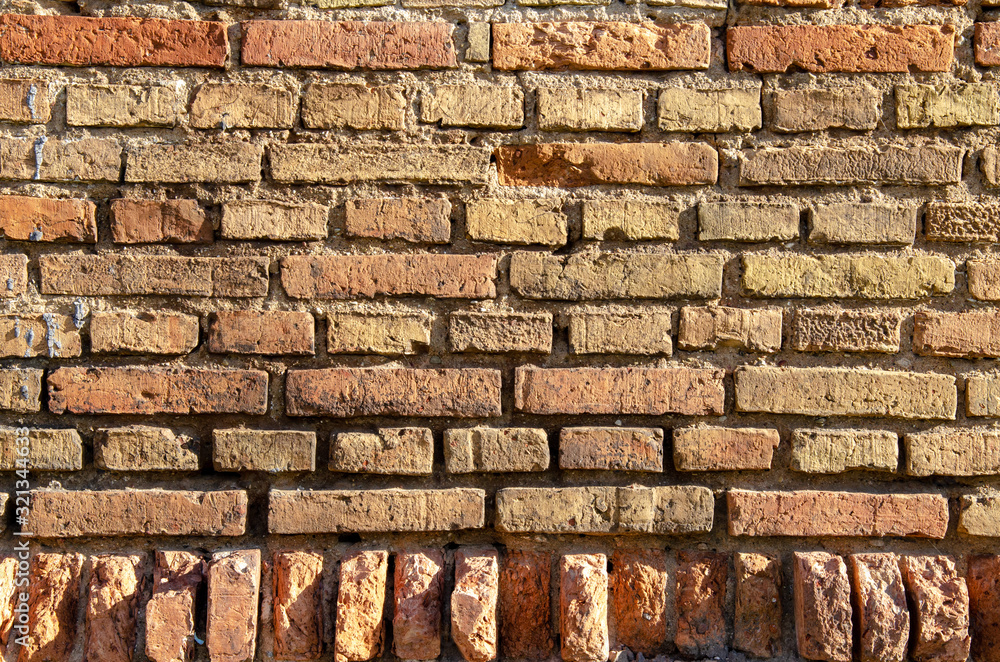 Old brick wall, old texture of red and orange blocks of stone. Closeup Old brick wall, old texture of red and orange blocks of stone. Closeup