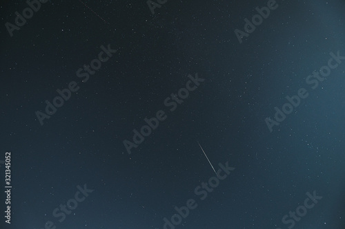 Night Starry Sky With Glowing Stars And Meteoric Track Trail. Meteorite Trail In Starry Sky Background