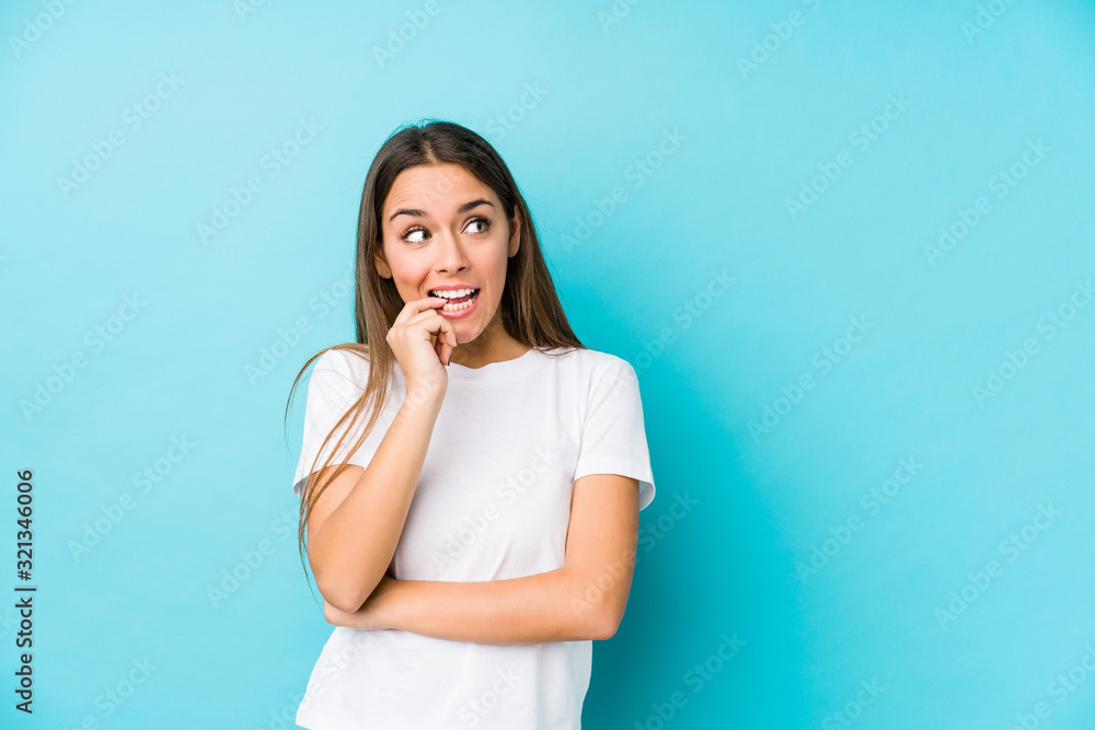 Young caucasian woman isolated relaxed thinking about something looking at a copy space. Young caucasian woman isolated relaxed thinking about something looking at a copy space.