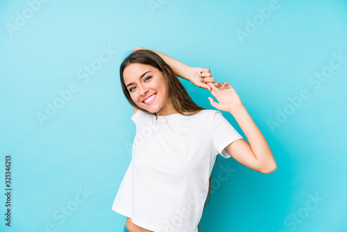 Young caucasian woman  isolated stretching arms, relaxed position.